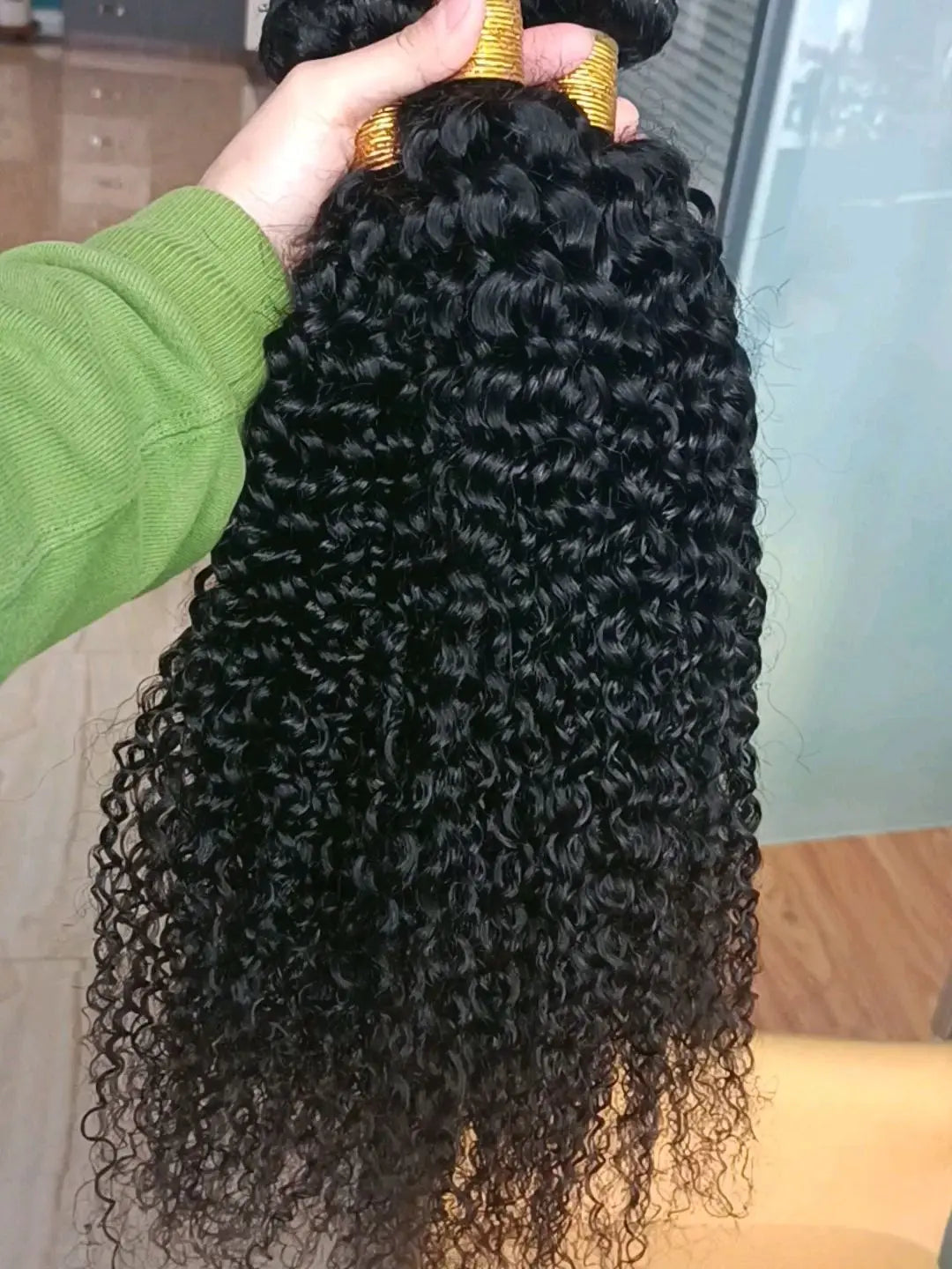 Curly, natural-colored human hair bundles